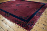 Vintage Nichols Art Deco carpet corner, dusty raspberry field, indigo border, floral sprays.
