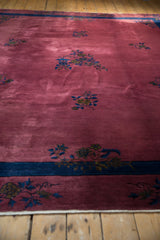 Dusty raspberry red field, indigo border with Art Deco floral sprays.