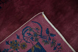 Vintage Nichols Art Deco carpet corner, revealing cochineal red pile, woven foundation, and indigo floral motifs.