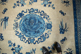 Antique Ningxia rug with cobalt blue dragon medallion, cloud bands, and geometric border.