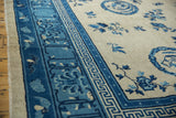 Antique Ningxia carpet border with blue geometric, lotus cloud band, and bat motifs.