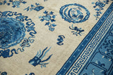 Angled view of antique Ningxia rug, blue fretwork, cloud band border, and field motifs.