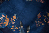 Nichols Art Deco carpet with rich indigo pile and pictorial blossoms in copper and raspberry.
