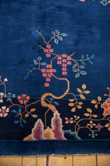 Vintage Nichols Art Deco carpet's pictorial landscape, raspberry blossoms, cobalt blue field, and fringe.