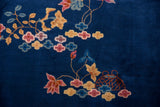 Indigo blue pile with raspberry lotus flowers, gold blossoms, and an orange lantern.
