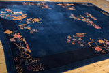 Art Deco carpet border with rich cobalt blue and intricate flowering branches in copper and raspberry.