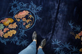 Deep navy blue pile on a Chinese Art Deco carpet, featuring floral roundel and bamboo.