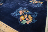 Navy blue Chinese Art Deco rug with floral roundel, lotus blooms, and bamboo.