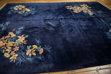 Lush blush, gold, jade floral spray with blue bamboo on a deep navy Art Deco rug.