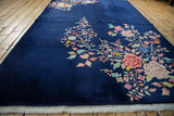 Vintage Art Deco rug, vibrant floral blossoms on cobalt blue, with fringe.