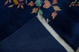 Reverse of vintage Art Deco carpet, with dark blue foundation and light fringed selvage.