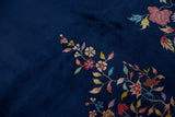 Colorful floral blossoms and delicate vinery on the deep cobalt blue Art Deco rug.