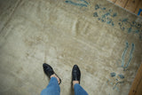 Distressed antique Peking carpet texture, with exposed foundation and blue vine border.