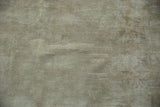 Worn beige pile and visible foundation on an antique distressed carpet.