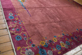 Vintage Nichols Art Deco carpet border with magenta floral sprays and dusty mauve field showing a crease.