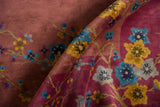 Rolled vintage Nichols Art Deco carpet pile, showcasing mauve, saffron yellow, and sky blue floral blossoms.