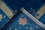 Vintage Chinese Peking carpet corner with cobalt blue floral patterns, beige border, and ivory fringe.