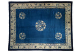 Antique Peking carpet with indigo blue field, central and corner medallions, and stylized ivory borders.
