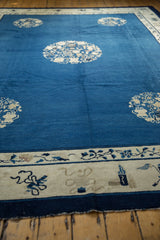 Antique Peking carpet corner with indigo field and ivory border featuring Taoist symbolism.