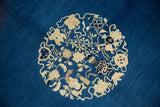 Collector's antique Peking carpet detail with indigo blue field, ivory stylized vinery and vase motifs.