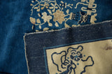 Original selvage, hand-knotted indigo back, and beige border with Taoist symbolism on antique Peking carpet.