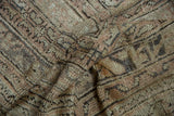 Textured pile of a distressed vintage Oushak rug with dusty rose and platinum geometric patterns.