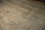 Thick, distressed Oushak rug pile texture with dusty rose and ivory floral motifs.