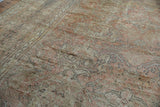 Thick, blanket-like distressed Oushak pile in dusty rose and beige with faded patterns.