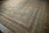 Vintage distressed Oushak carpet corner with meandering borders; dusty rose, beige, charcoal.