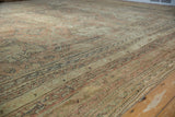 Distressed vintage Oushak carpet with knot heads, dusty rose, antique ivory, and softened curvilinear patterns.
