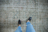 Vintage distressed Sivas carpet texture with faded seafoam green and antique ivory floral palmettes.