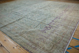 Distressed floral palmette field and violet border on a vintage Sivas carpet.
