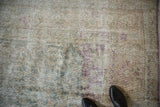 Distressed Sivas carpet showing foundation wear and faded aubergine floral palmettes.