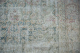 Distressed vintage Sivas carpet detail with worn pile, visible foundation, and faded floral palmettes.