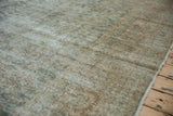Distressed Turkish Sivas carpet showing worn texture, seafoam green and beige shades, fringe.