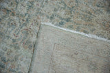 Distressed vintage Sivas rug, revealing seafoam green floral pile and hand-knotted foundation.