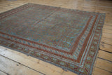 Distressed Afshar carpet, ocean blue field, terracotta and bronze patterned borders.
