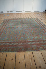 Vintage distressed Afshar carpet with time-softened ocean blue, chestnut, and terracotta hues.