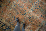 Vintage Mahal carpet's ornate floral bouquets and long stemmed vinery on dusty terracotta field.