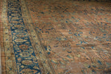 Dusty terracotta field detail of vintage Mahal carpet, showing ornate floral vinery and navy border abrashes.