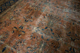 Ornate floral vinery with abrashes on vintage Persian Mahal rug in terracotta, navy, and dusty teal.