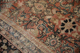 Distressed Persian Mahal carpet pile, with faded brick red, beige, and black Herati motif.