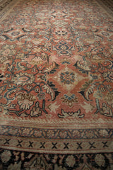 Distressed vintage Mahal carpet border, geometric Xs, faded brick red and beige field.
