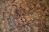 Distressed vintage Mahal rug texture, showing worn brick red pile, ivory, and blue Herati floral vinery.