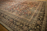 Distressed vintage Mahal carpet border detail, showing faded red, beige, black, and blue traditional patterns with worn texture.