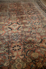 Textured, distressed pile of Mahal carpet revealing faded brick red and sapphire blue Herati motifs.