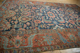Intricate brick red main border and geometric cobalt blue floral field on an antique Gorevan carpet.