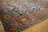 Wide meandering vine border and geometric floral field of antique Gorevan carpet.