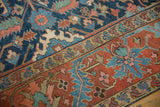 Antique Gorevan carpet's cobalt blue field with geometric vinery, framed by a meandering vine border in brick red and tan.