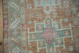 Even wear across the knot heads revealing the wool texture of a distressed Karaja rug.